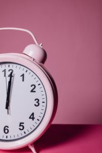 A Pink Clock on Table