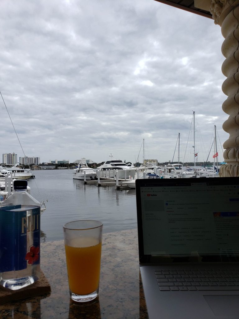 working on laptop at a marina