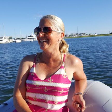 Anne in the dinghy with shades on